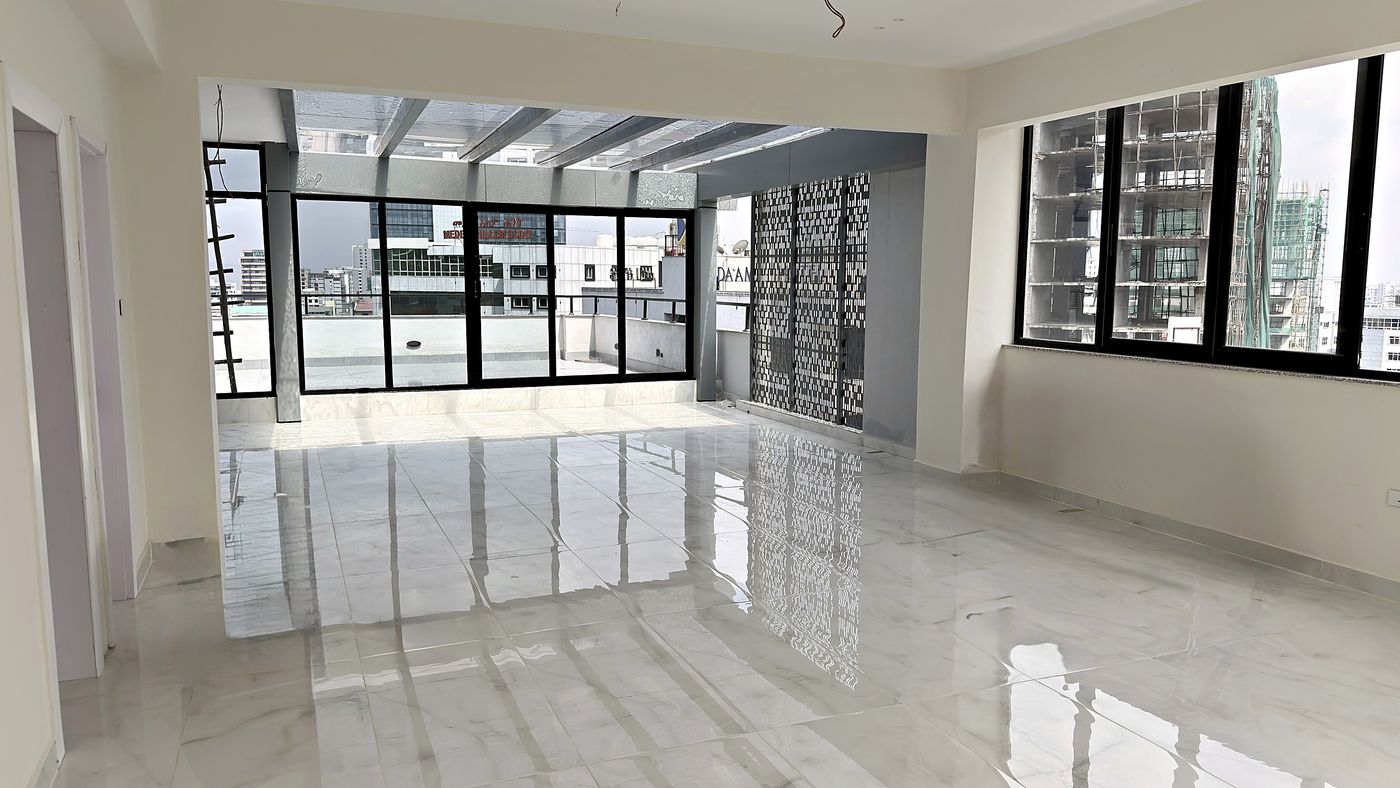 The top floor opening onto the rooftop terrace, with the Bole skyline beyond