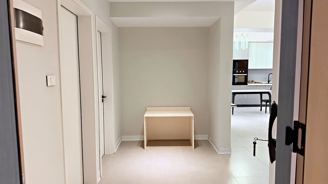 Entrance hall with a desk nook and the kitchen beyond