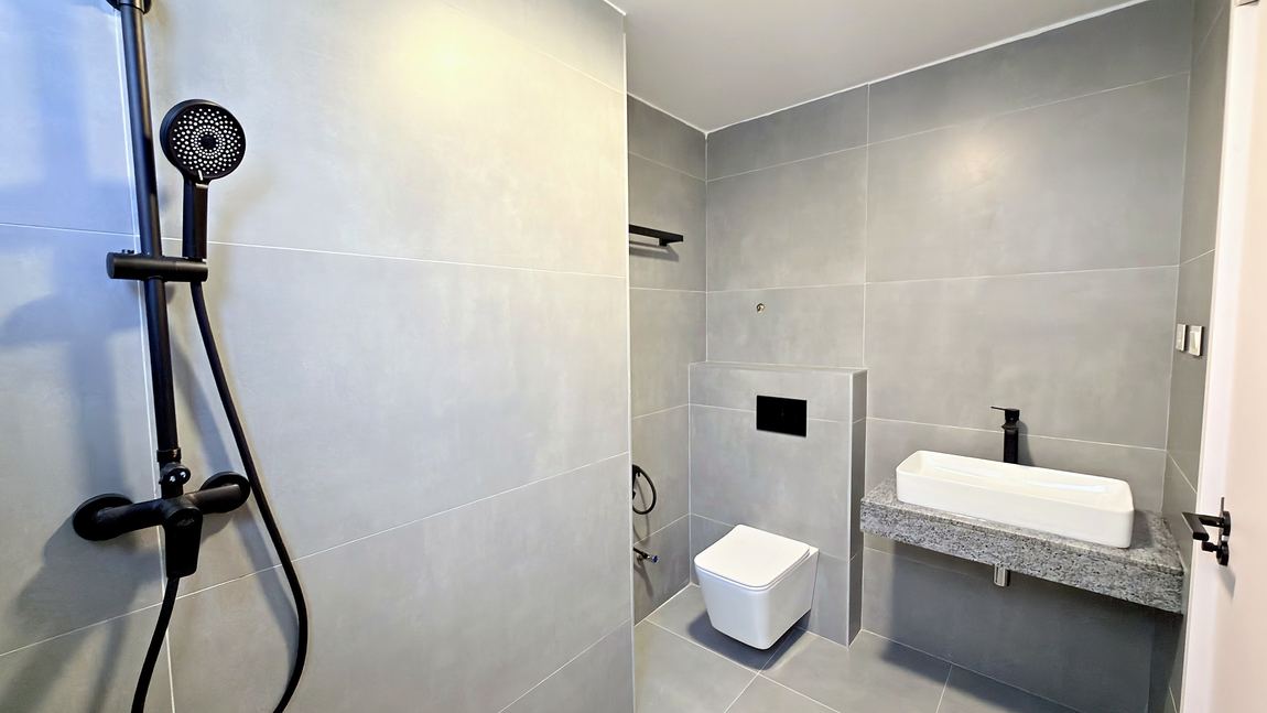 Bathroom with a walk in rain shower and stone vanity