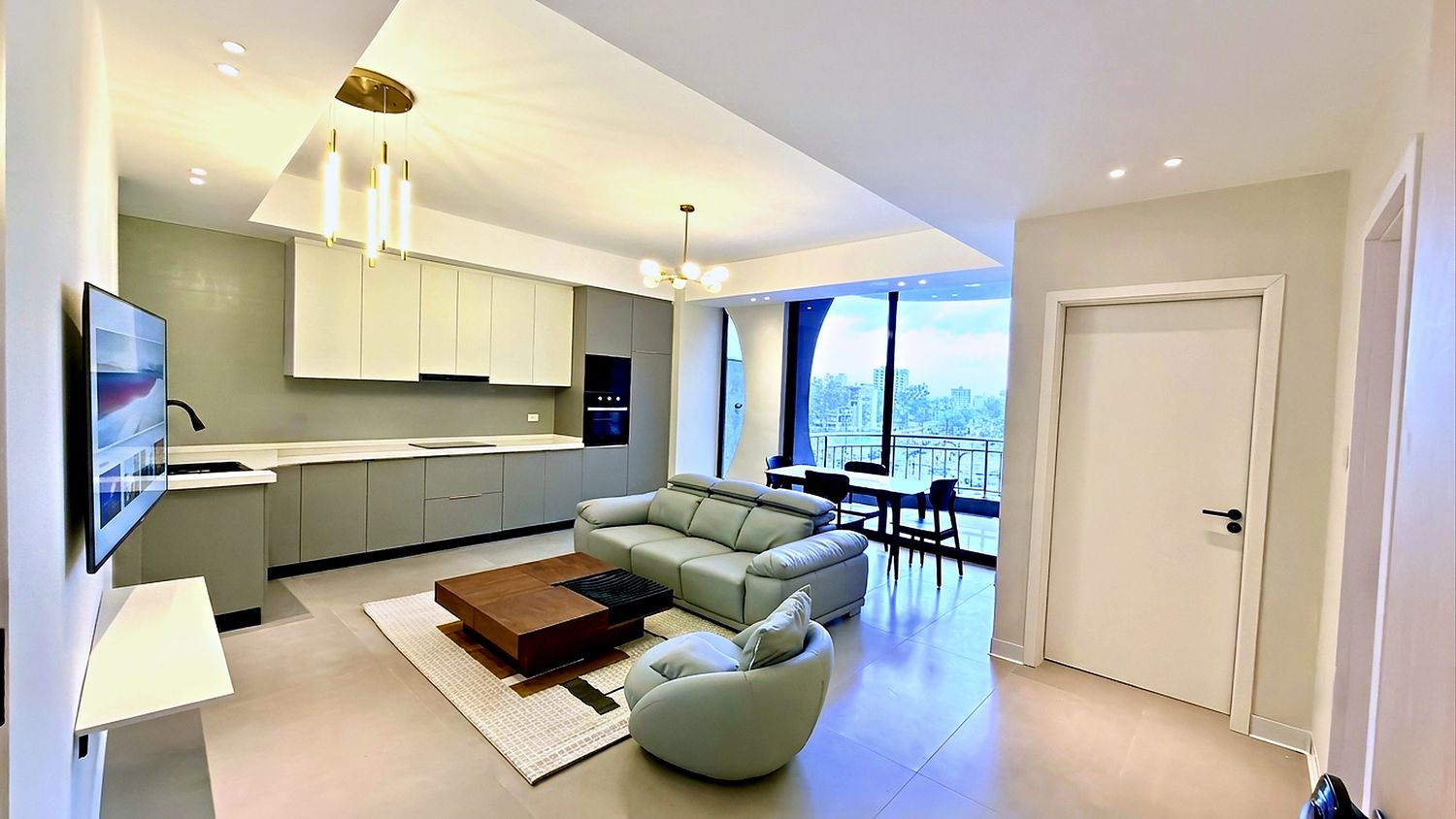 One bedroom apartment with an open kitchen, sitting area and a balcony looking over Bole